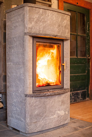 The woodstove is a Tulikivi, made in Finland. It was a floor model.