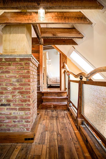 At the top of the stairs, you can go either left or right. The floor is hickory, and those bricks date back more than a century.