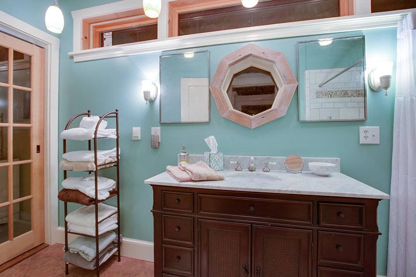 The vanity has a Carrera marble top. Those mirrors are from a hotel, and that's old chestnut around the center window.